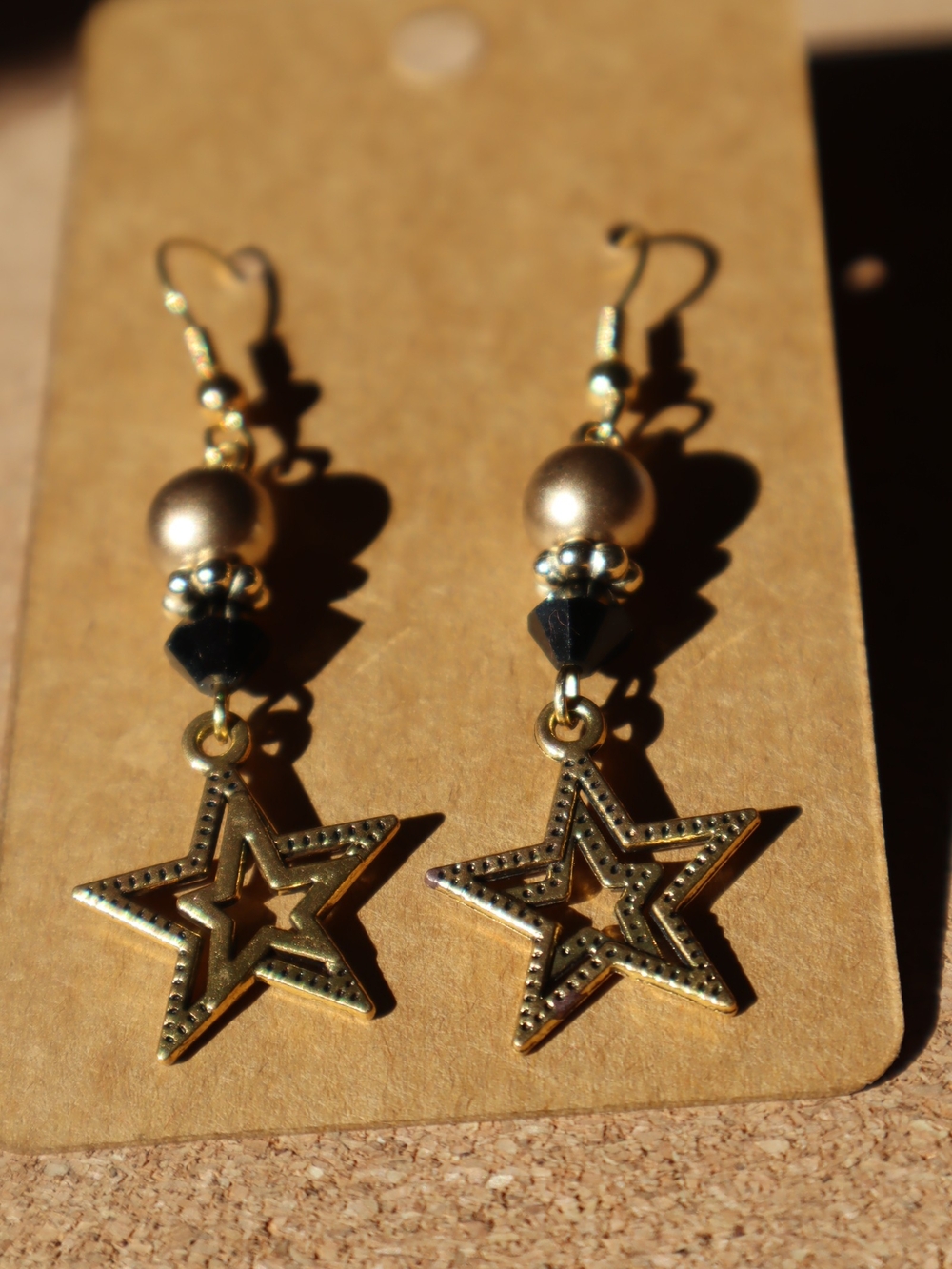Handmade Gold Star Drop Earrings with Black Accent
